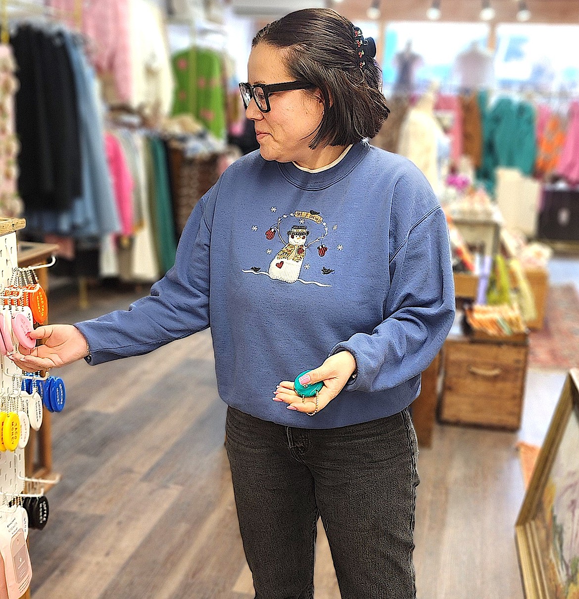 Carmen Burke, owner of The Little Shop Montana, displays a "squeezy" coin purse, one of the many fun vintage inspired or vintage items in her fun shop. (Berl Tiskus/Leader)