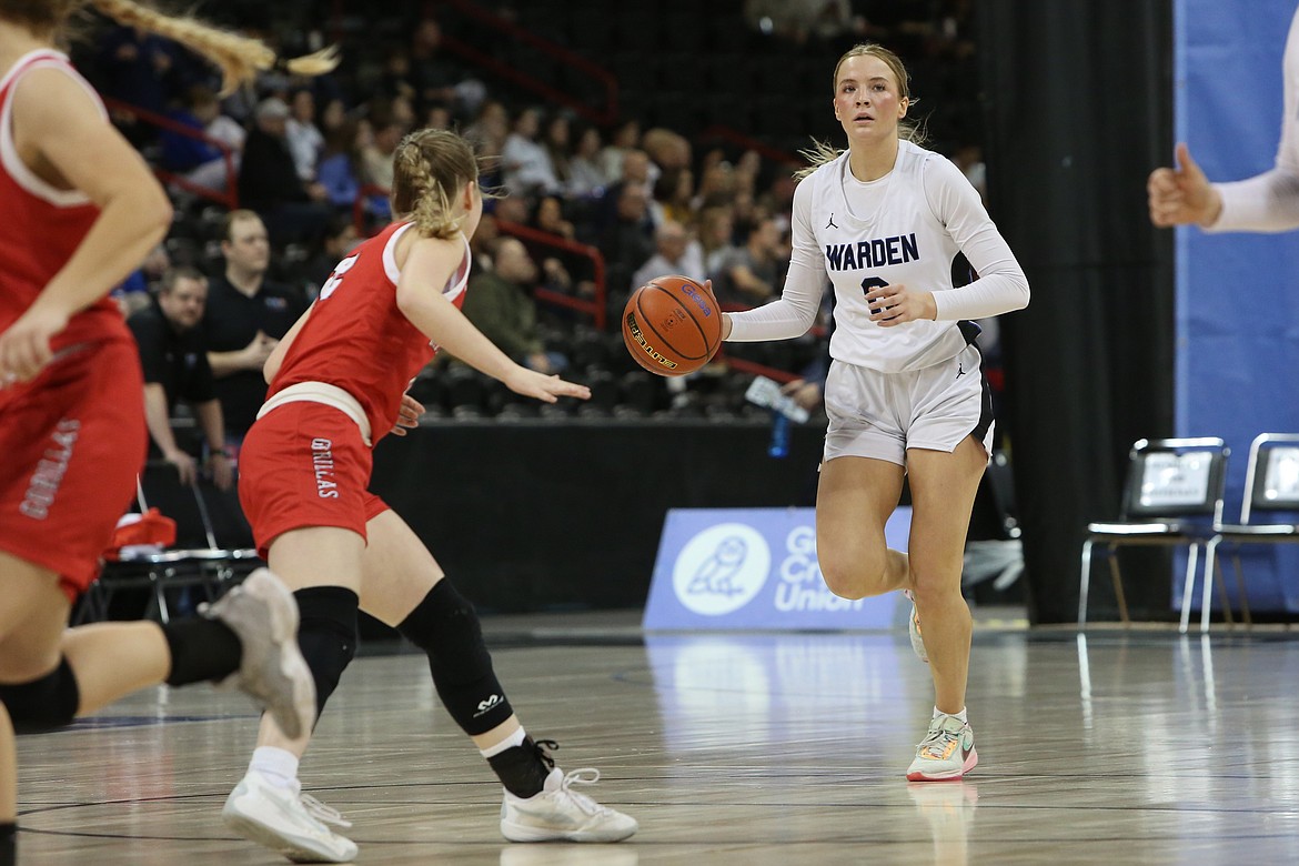 Warden senior Lauryn Madsen takes the ball up the court against No. 10 Davenport. The Warden Cougars took third place at the 2B Girls State Basketball Tournament, placing in the top three at state for the third straight season.