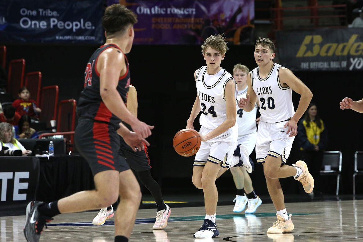 MLCA/CCS sophomore Johnny Ferguson (24) dribbles the ball up the floor against No. 5 Neah Bay. The Lions took fourth in the 1B Boys State Basketball Tournament, defeating No. 1 seed Lummi Nation in the fourth/sixth-place game.