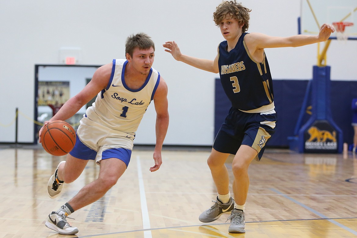 Soap Lake senior Pavlo Stoyan, left, dribbles the ball up the floor against Riverside Christian in the Central Washington 1B district tournament. The Eagles got back to the 1B Boys State Basketball tournament for the first time since 2014