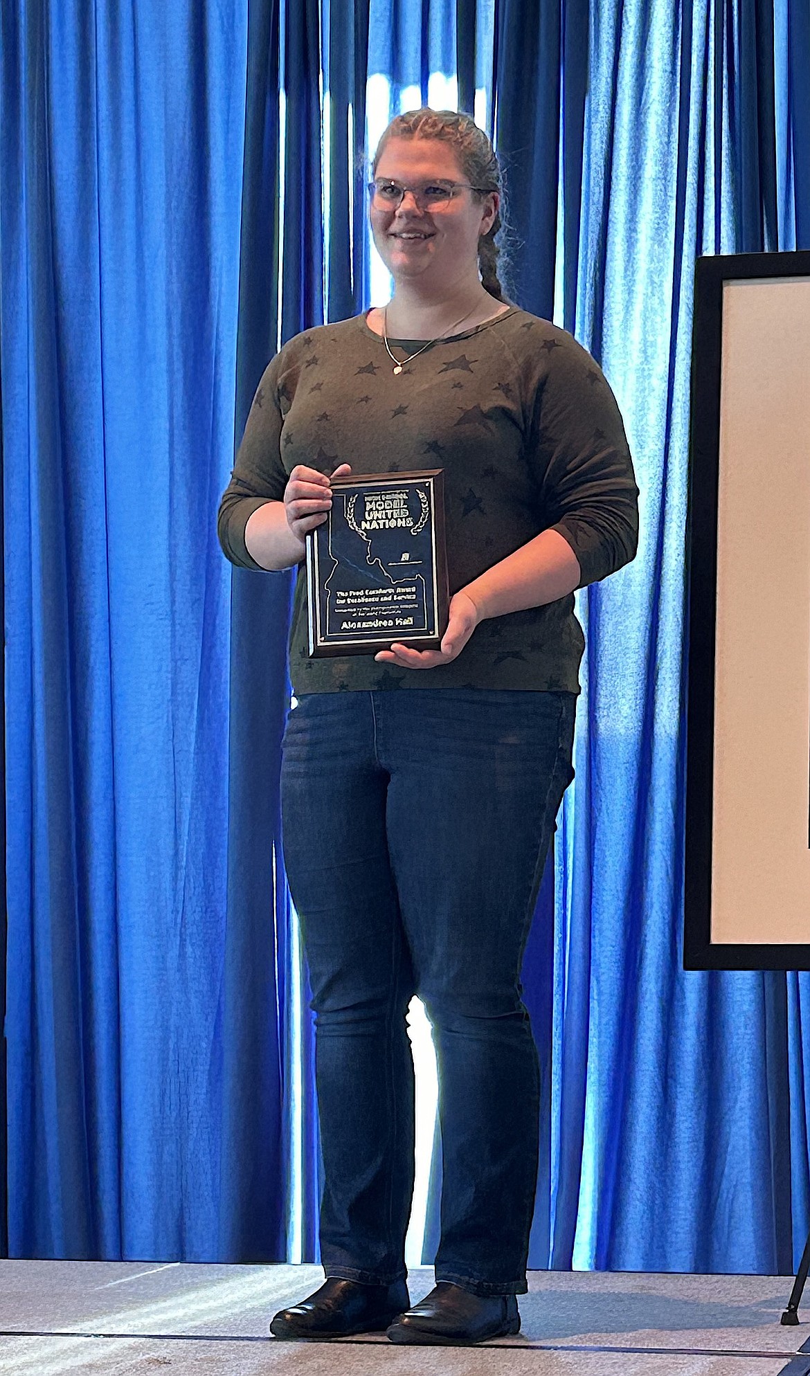 Alexandrea Hall stands with the Fred Cornforth Award she earned during the 2024 Model U.N. Competition at Boise State University.