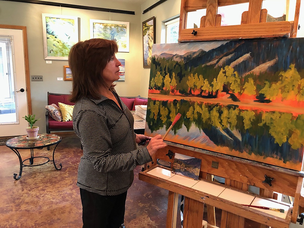 Terrel Jones is pictured in her studio working on another painting.