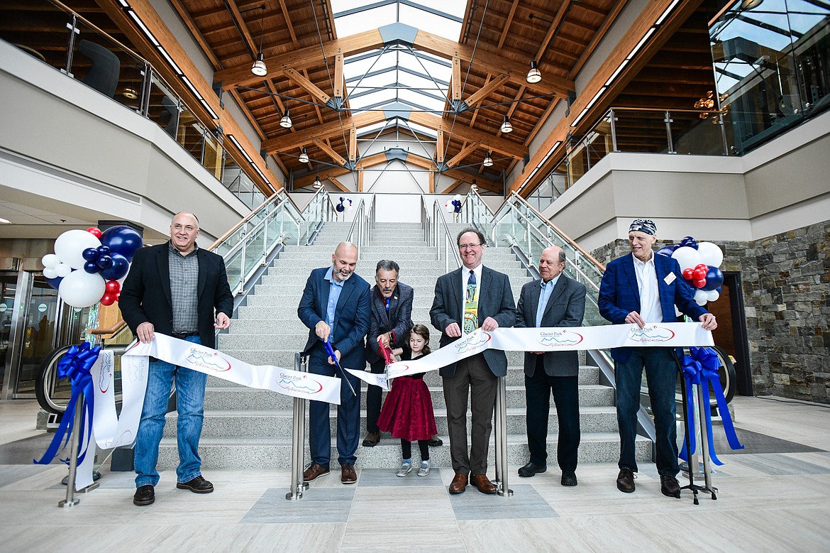 Airport director Rob Ratkowski cuts the ribbon during a ribbon-cutting ceremony at Glacier Park International Airport on Tuesday, March 5. (Casey Kreider/Daily Inter Lake)