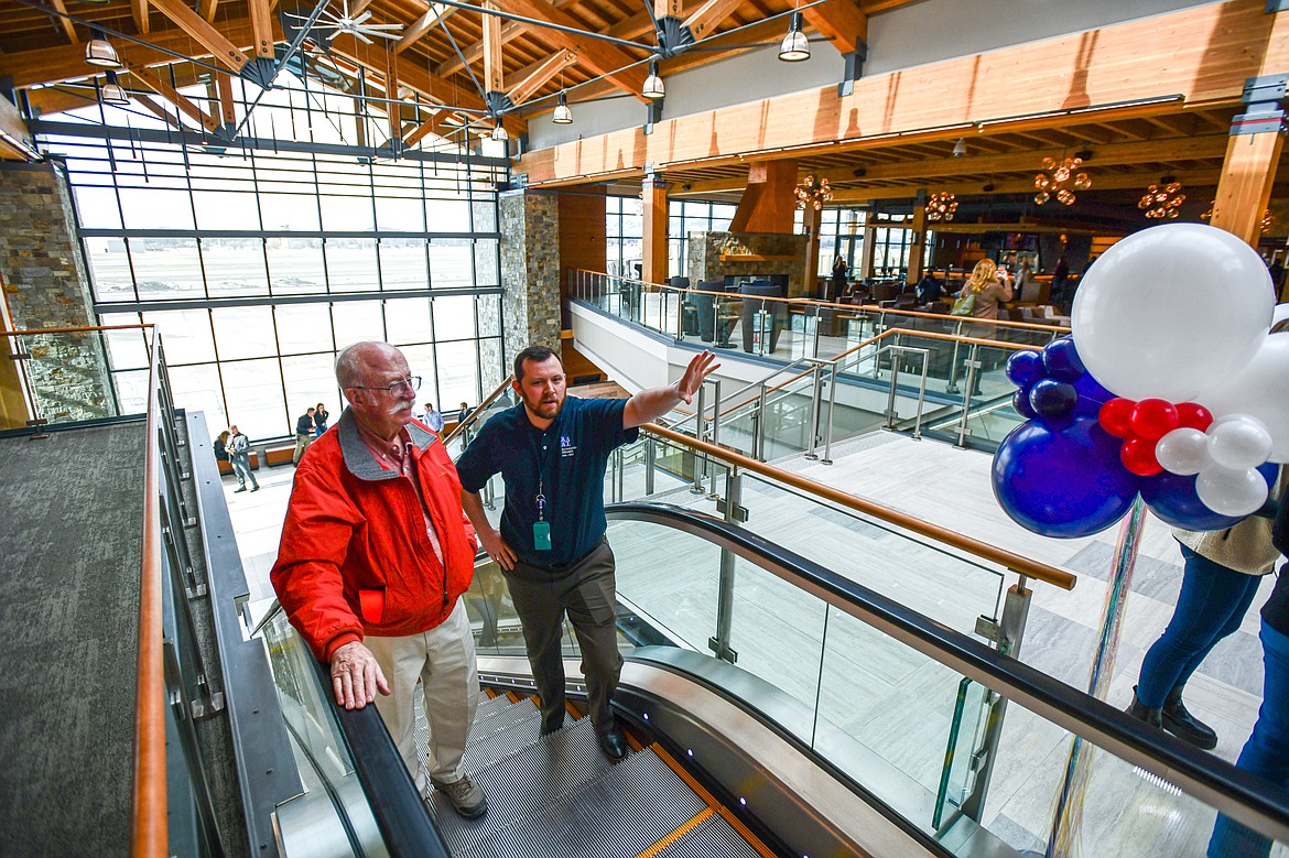 Attendees ride the escalator during a ribbon-cutting ceremony at Glacier Park International Airport on Tuesday, March 5. (Casey Kreider/Daily Inter Lake)