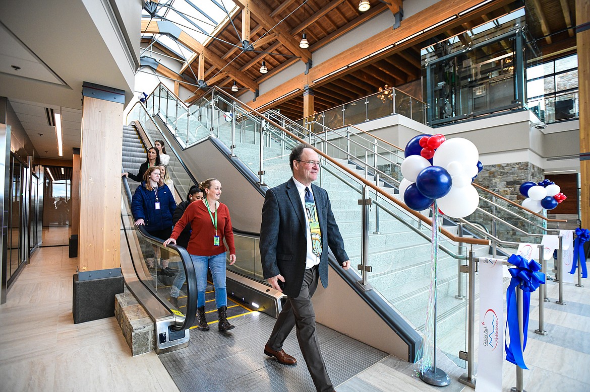 Attendees ride the escalator during a ribbon-cutting ceremony at Glacier Park International Airport on Tuesday, March 5. (Casey Kreider/Daily Inter Lake)