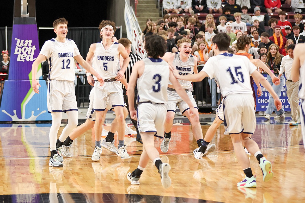Bonners Ferry boys basketball celebrate on the court as the win the 3A State Championship over Teton 54-47 on March 2.
