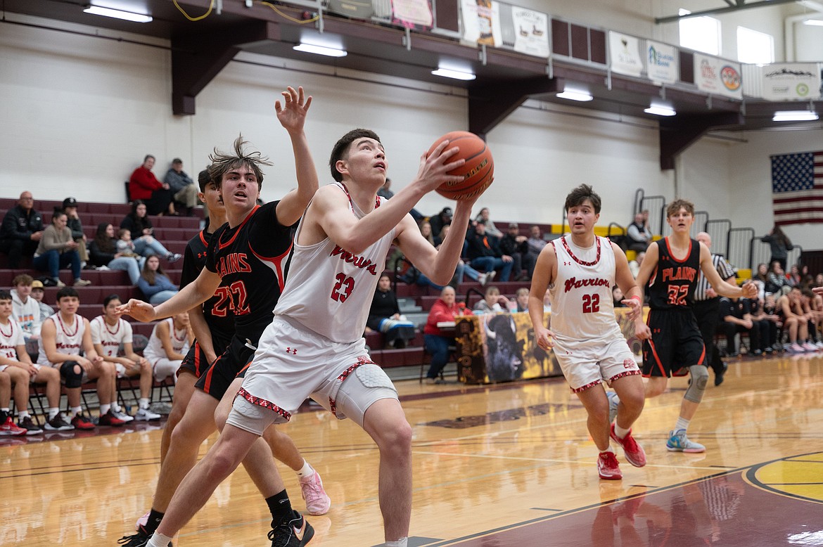 Warrior Benjamin Harlow-Old Person looks for an opening against Plains during the Divisional Tourney at Salish Kootenai College in Pablo. The Warriors secured a 82-53 victory over the Horsemen. (Christa Umphrey photo)