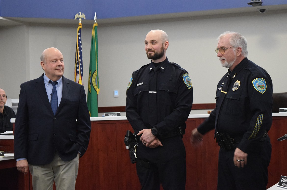 Othello Mayor Shawn Logan, left, Othello Police Officer Bryan Jacobsen, middle, and Othello Chief of Police Dave Rehaume, right, conduct the ceremony for Jacobsen’s promotion to Patrol Sergeant during Monday’s Othello City Council Meeting.