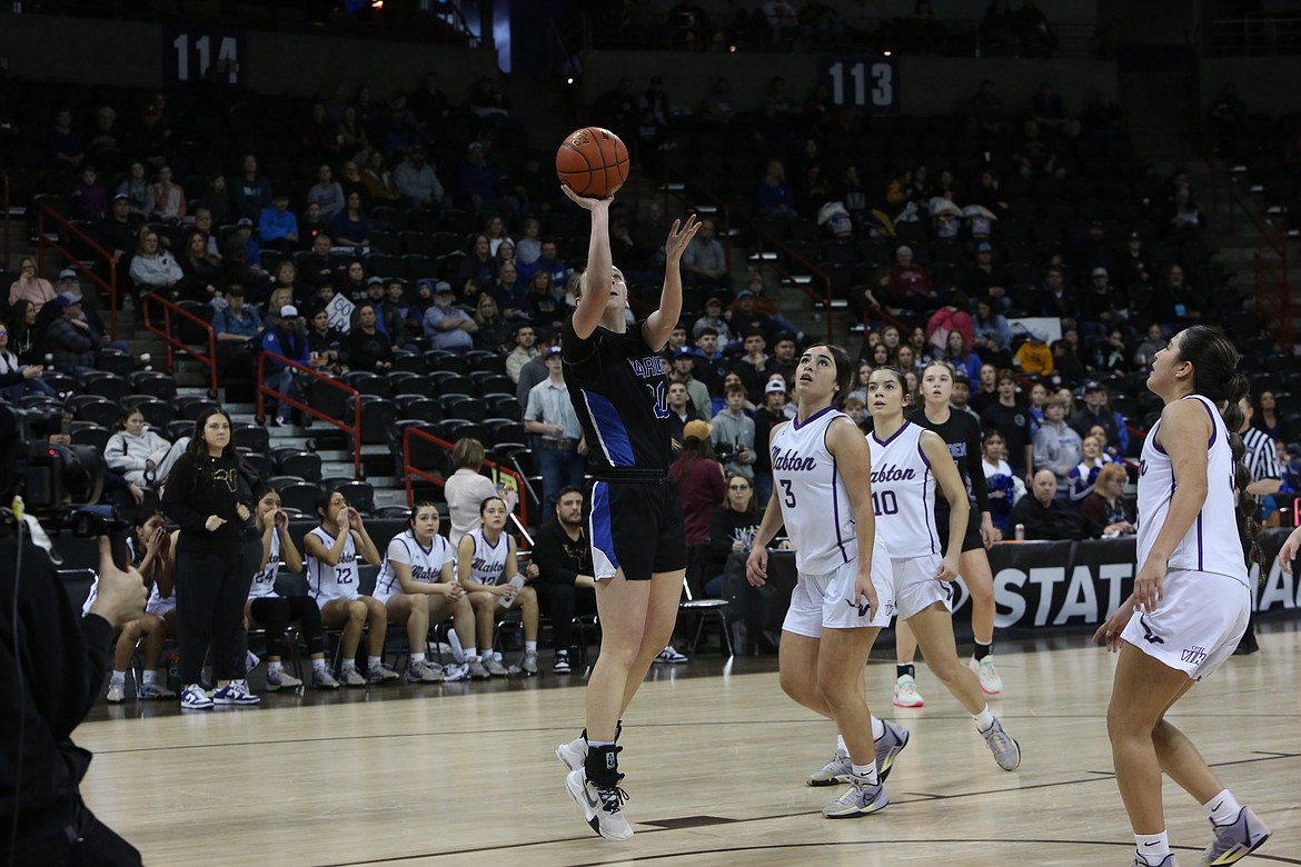 Warden senior Molly Sackmann, in black, lays the ball up for a basket against Mabton in the 2B Girls State Basketball Tournament quarterfinals.