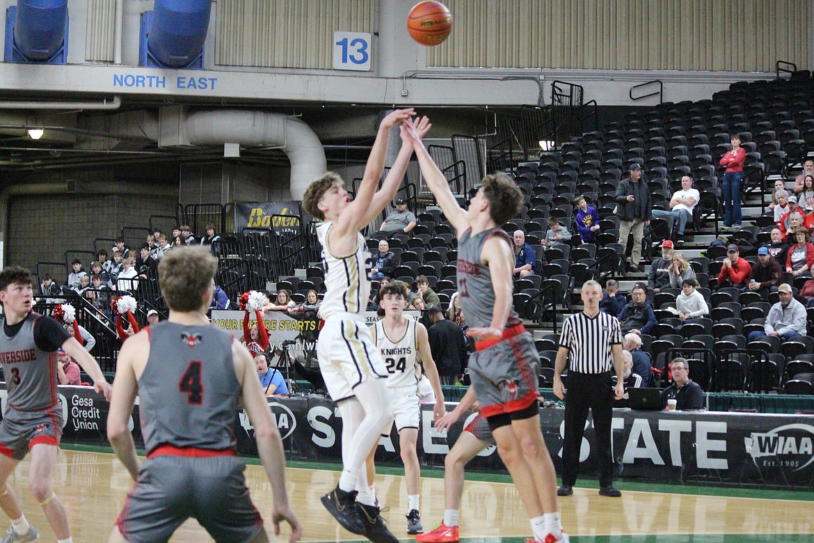 Royal senior Caden Allred, in white, shoots the ball against Riverside at the 1A Boys State Basketball Tournament in Yakima.