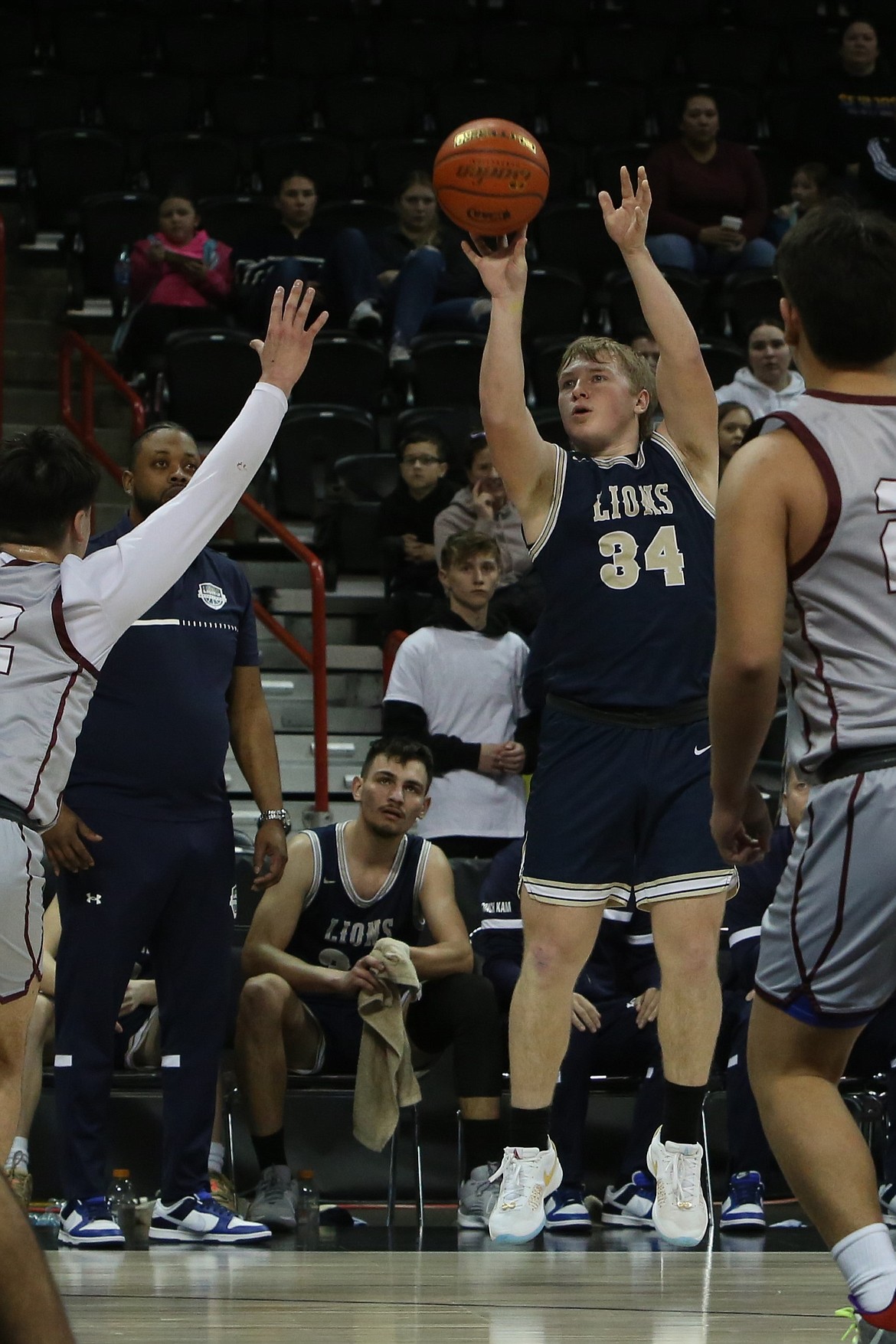 MLCA/CCS senior Jonah Robertson (34) attempts a three-pointer against Lummi Nation at the 1B Boys State Basketball Tournament.