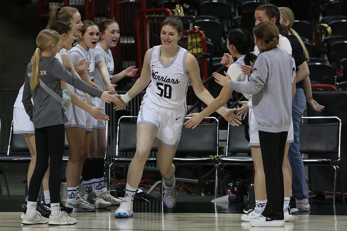 Almira/Coulee-Hartline sophomore Emma Brummett (50) high-fives teammates as she walks on the court during player introductions.