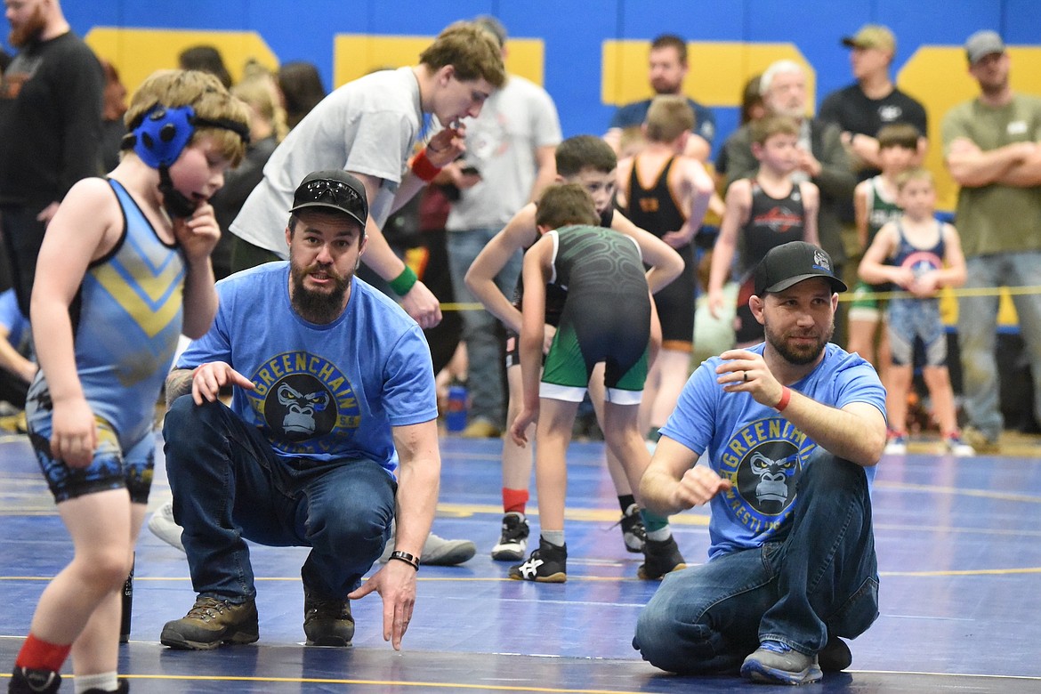 Libby Wrestling Club president Jason Harrington, right, and fellow coach Cody Elliot encourage one of their wrestlers at the Kootenai Klassic on Saturday, March 1, 2024, at Libby High School. (Scott Shindledecker/The Western News)