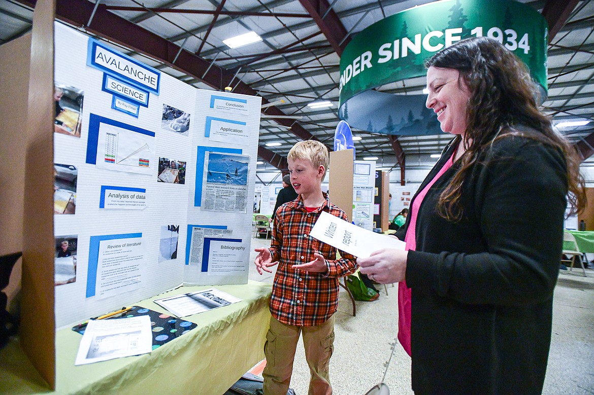 Ray Elmer, a fourth-grader at Kalispell Montessori, describes his project "Avalanche Science" to a judge at the Flathead County Science Fair at the Flathead County Fairgrounds Expo Building on Thursday, March 7. (Casey Kreider/Daily Inter Lake)