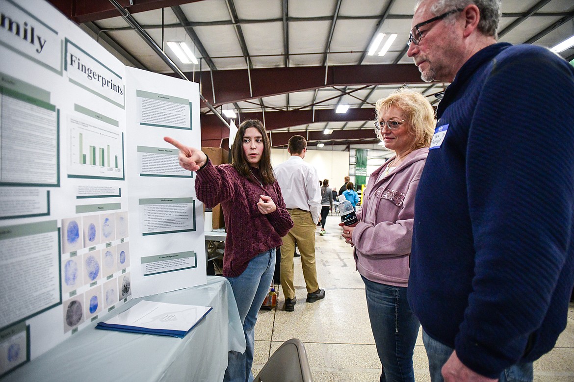 Glacier High School freshman Kinsey Bergman describes her project "Family Fingerprints," which sought to determine the likelihood of certain genetic traits being passed from a mother or father to a child, to judges at the Flathead County Science Fair at the Flathead County Fairgrounds Expo Building on Thursday, March 7. (Casey Kreider/Daily Inter Lake)