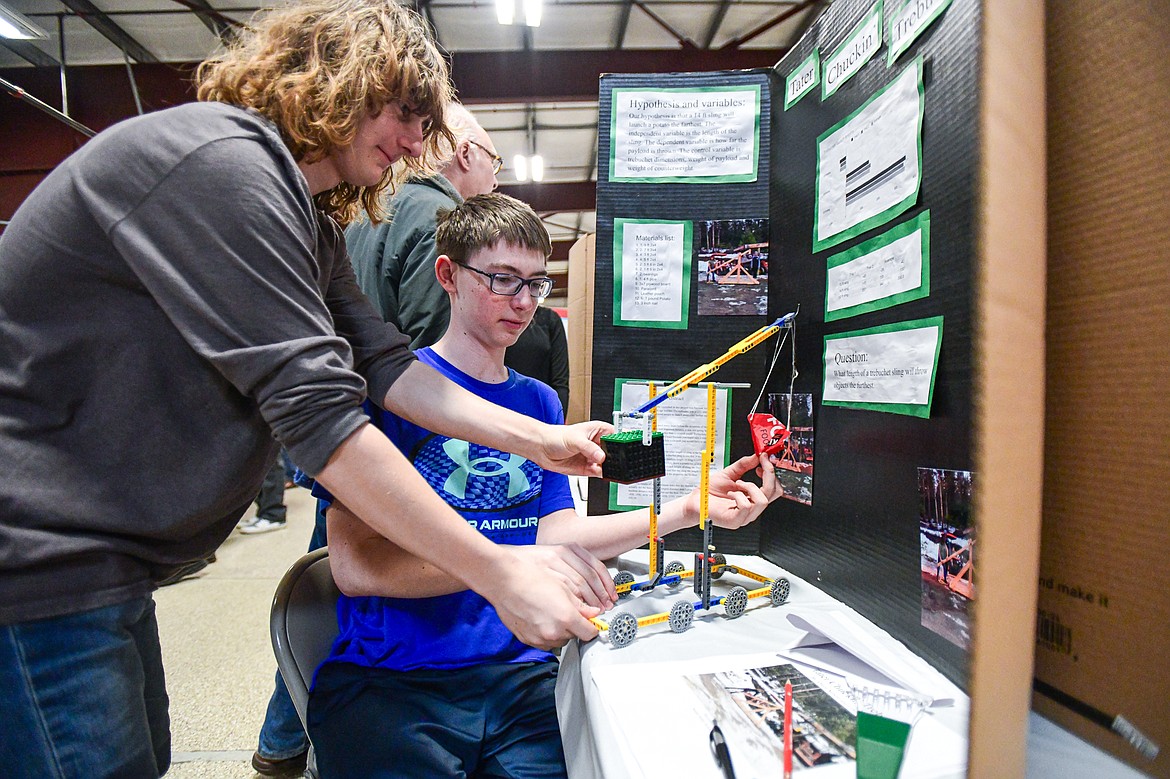 Smith Valley School eighth-graders Luke Amundson, left, and Owen Nelson make an adjustment to their project titled "Tater Chuckin' Trebuchet" at the Flathead County Science Fair at the Flathead County Fairgrounds Expo Building on Thursday, March 7. (Casey Kreider/Daily Inter Lake)