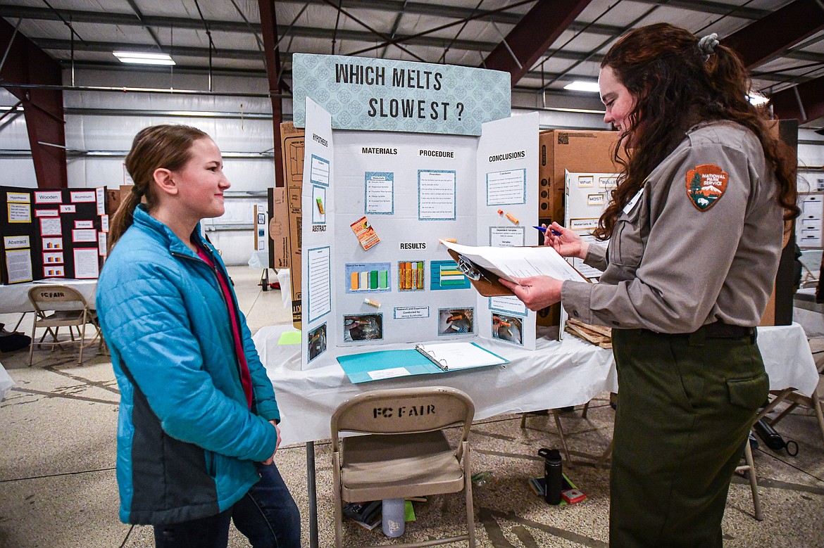 Trinity Lutheran School seventh-grader Jenica Burkholder talks with a judge about her project titled "Which Melts Slowest," determining which lip balm melts the slowest when placed in a pancake skillet on a stove, at the Flathead County Fairgrounds Expo Building on Thursday, March 7. (Casey Kreider/Daily Inter Lake)