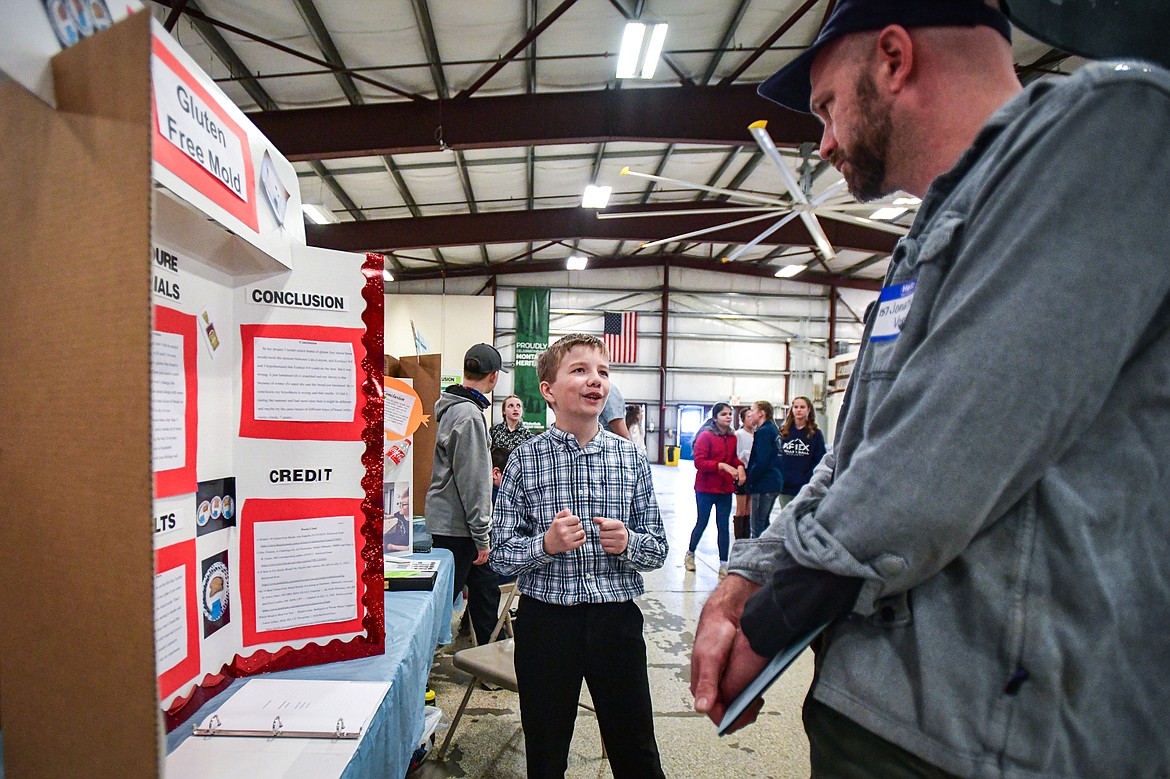Emmitt Dose, a seventh-grader at Trinity Lutheran School, describes his project "Gluten Free Mold," which sought to determine which brand of gluten free bread molds the slowest, to a judge at the Flathead County Science Fair at the Flathead County Fairgrounds Expo Building on Thursday, March 7. (Casey Kreider/Daily Inter Lake)