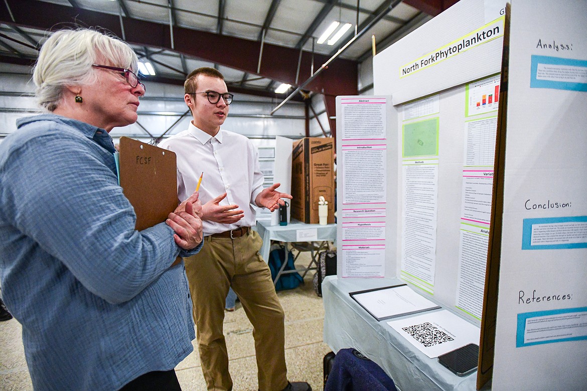 Glacier High School sophomore Edward McNeil describes his project "North Fork Phytoplankton" to a judge at the Flathead County Science Fair at the Flathead County Fairgrounds Expo Building on Thursday, March 7. (Casey Kreider/Daily Inter Lake)