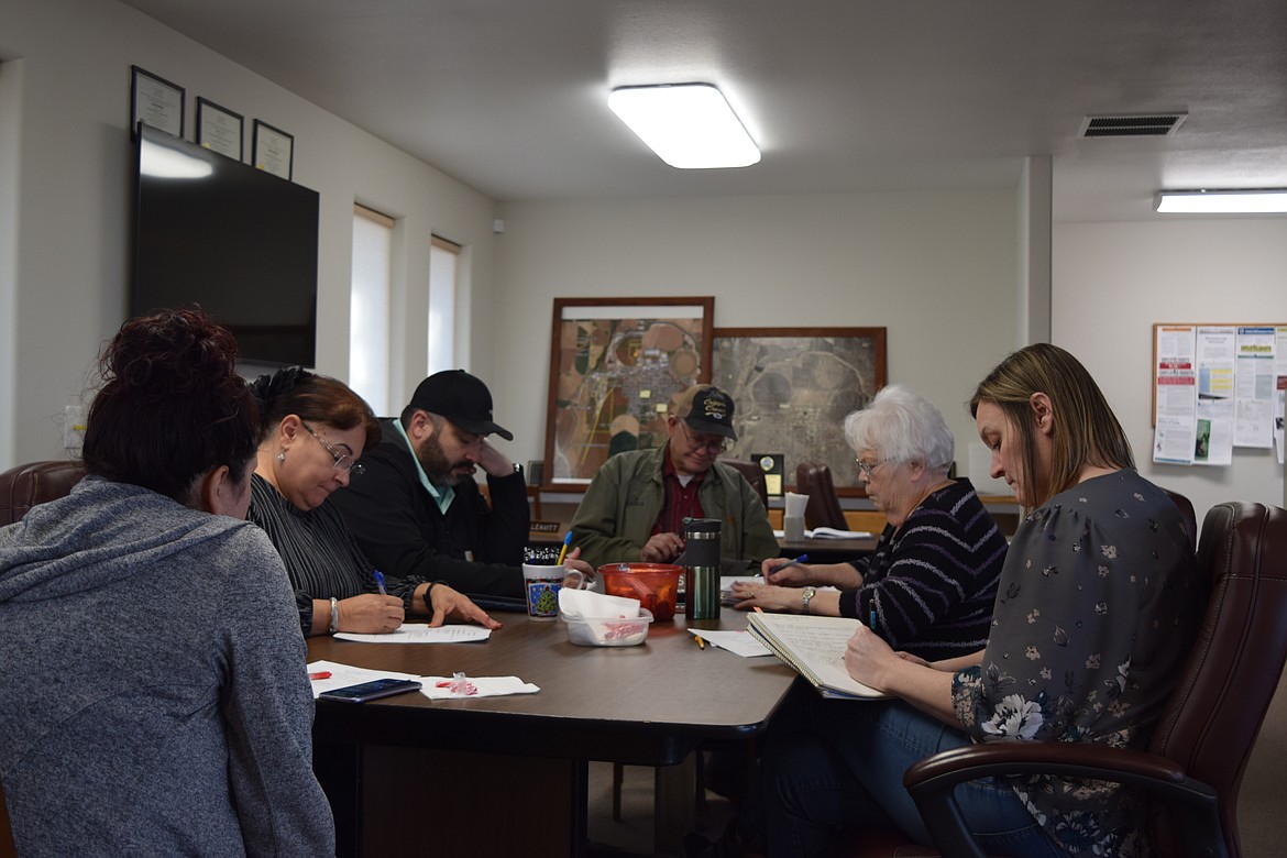 Port of Warden Commissioners, staff and guests, including Warden Mayor Rosaelia Martinez, second from left, discuss port business during Thursday’s regular meeting at the port’s offices in Warden