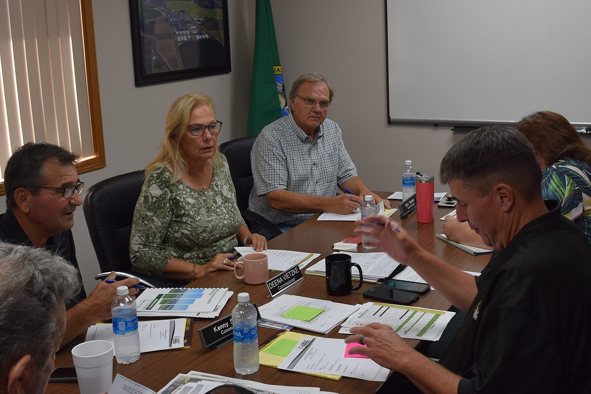 Othello Port Commissioner Deena Vietzke, left middle, honored as the 2023 Woman of the Year by the Greater Othello Chamber of Commerce during its Annual Awards Banquet in February, discusses port business during an August meeting.