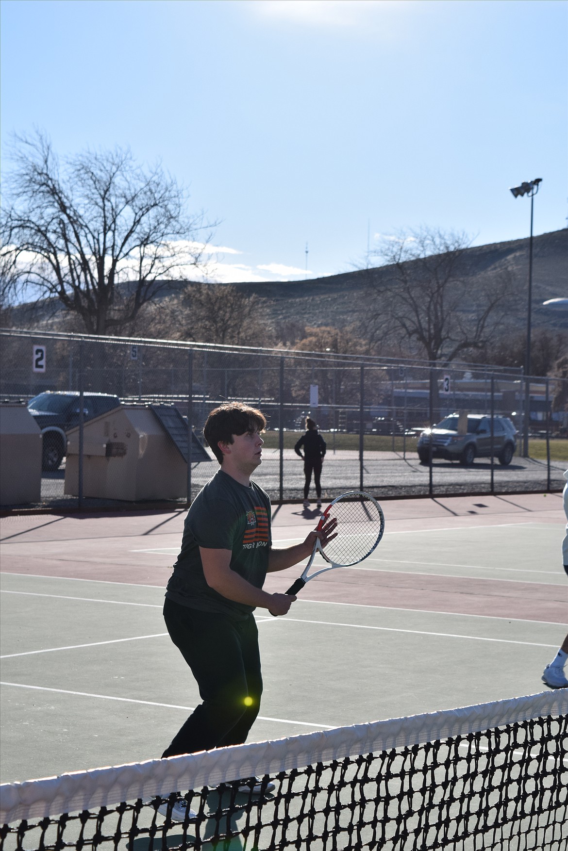 Bowen Summers works close to the net during drills at Tuesday’s boys tennis practice. Summers and his teammates are working to make sure they can get to the ball and hit it back regardless of their proximity to the net.