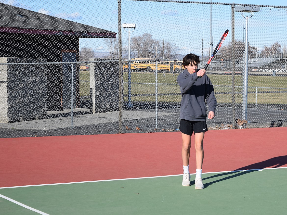 Jett Julian loosens up while working on doubles play during Tuesday’s practice. Coach Courtney Burck is working to ensure Tiger tennis players are agile and ready to go after the ball aggressively as they move into preseason play this weekend.