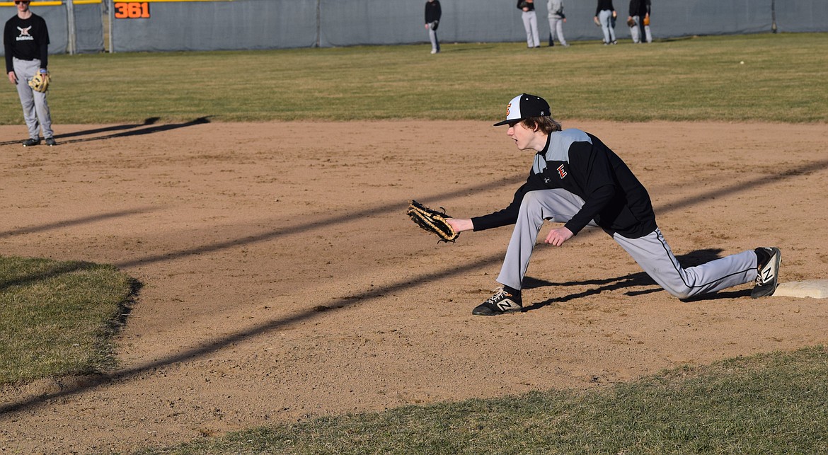 Caleb Froewiss scoops a ball during drills on Tuesday. Tiger Head Baseball Coach David Tempel said solid infield and outfield skills should serve Ephrata High well on the diamond this year.