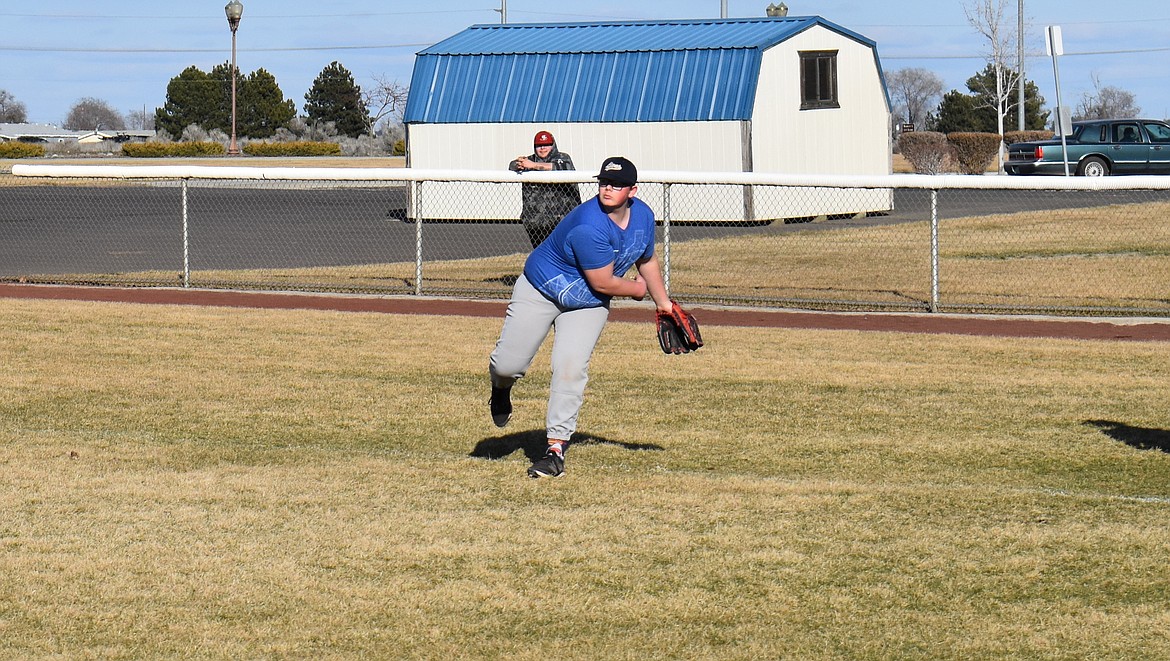 Moses Lake Christian Academy/Covenant Christian School pitcher Branden Schober follows through on a throw as the Lions warm up for practice Thursday.