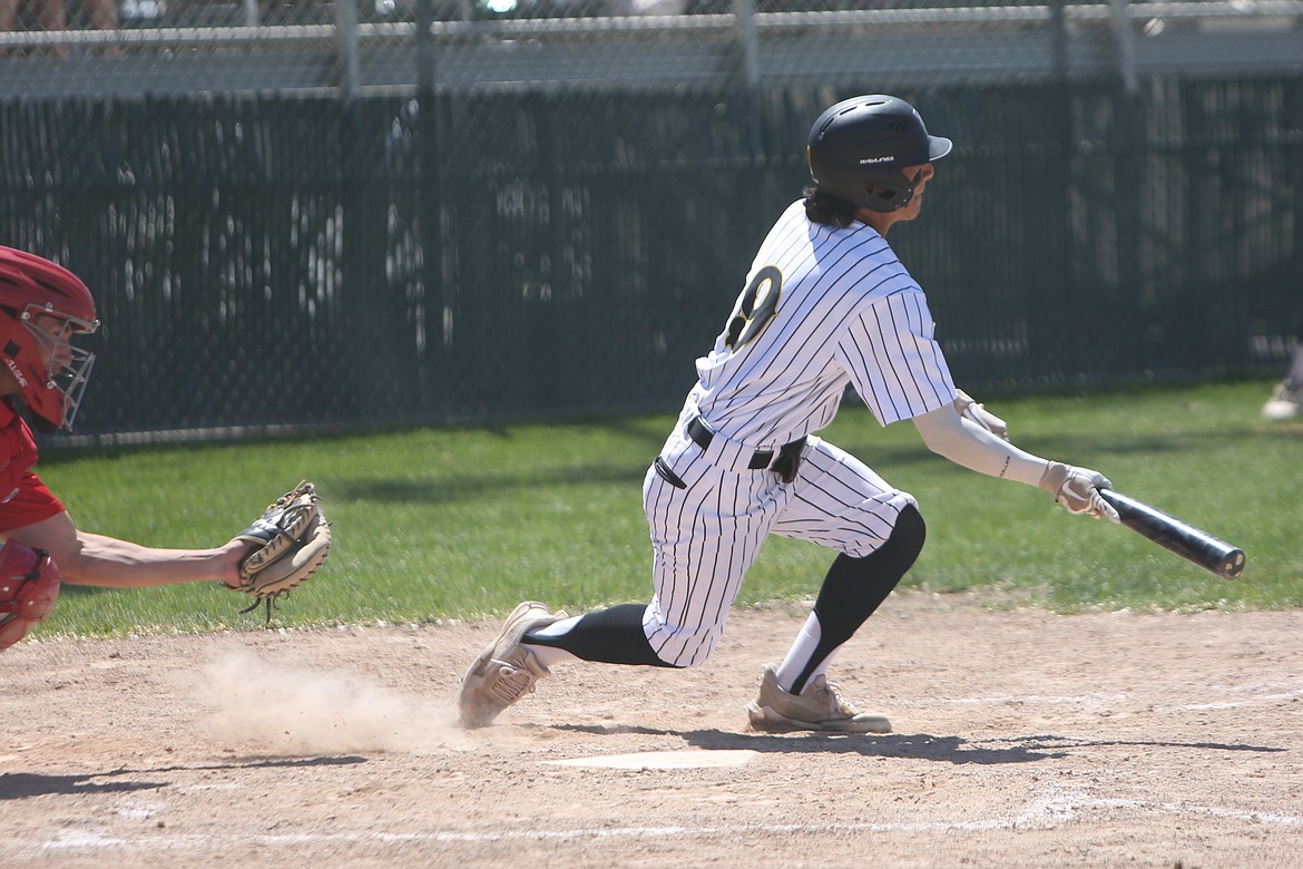 Moses Lake junior Jackson Carlos, right, gets ready to run to first base after making contact with a pitch.