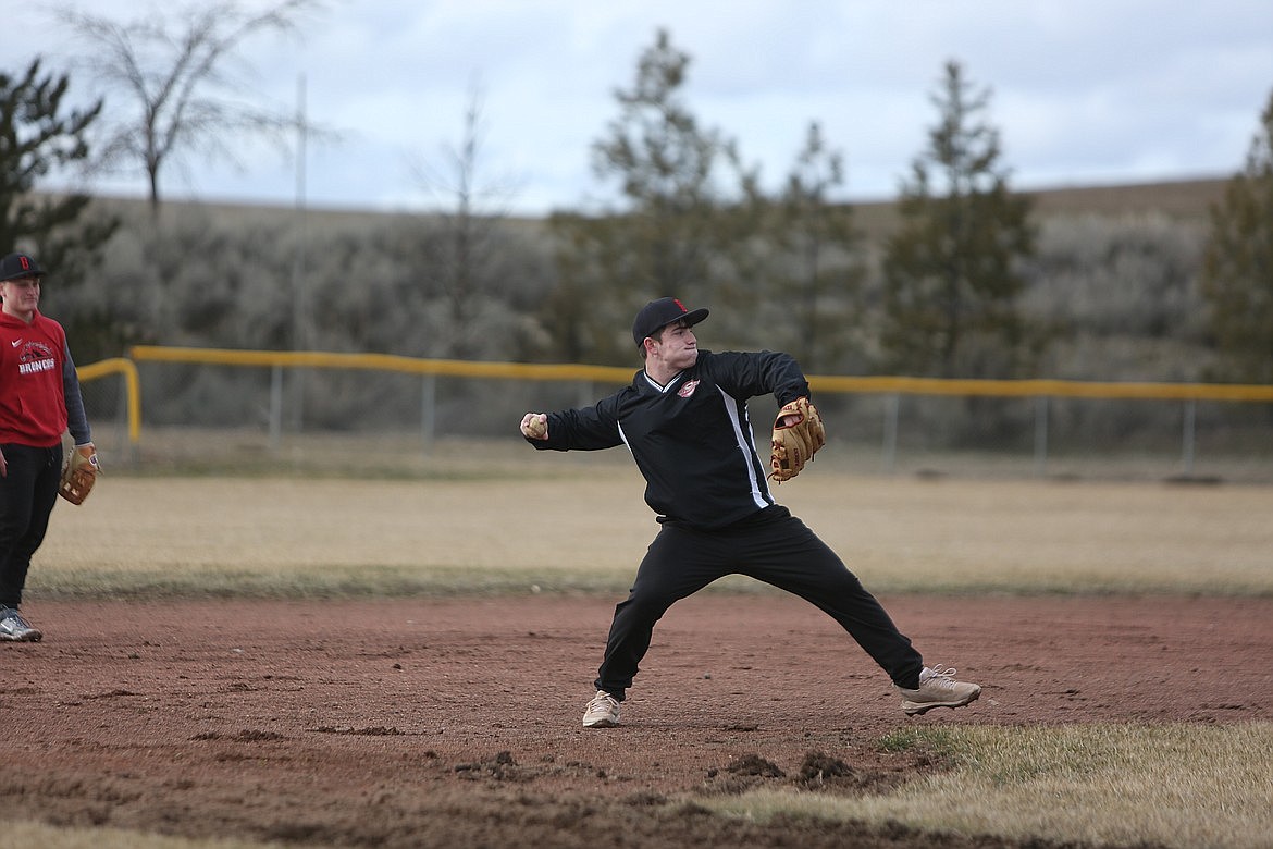 Lind-Ritzville/Sprague Baseball player Brody Boness throws to first base after fielding a ball in the infield during a practice in the 2023 season.