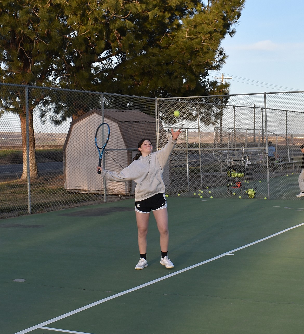 Hayden Sutor gets ready to serve at Royal High School tennis practice Thursday.