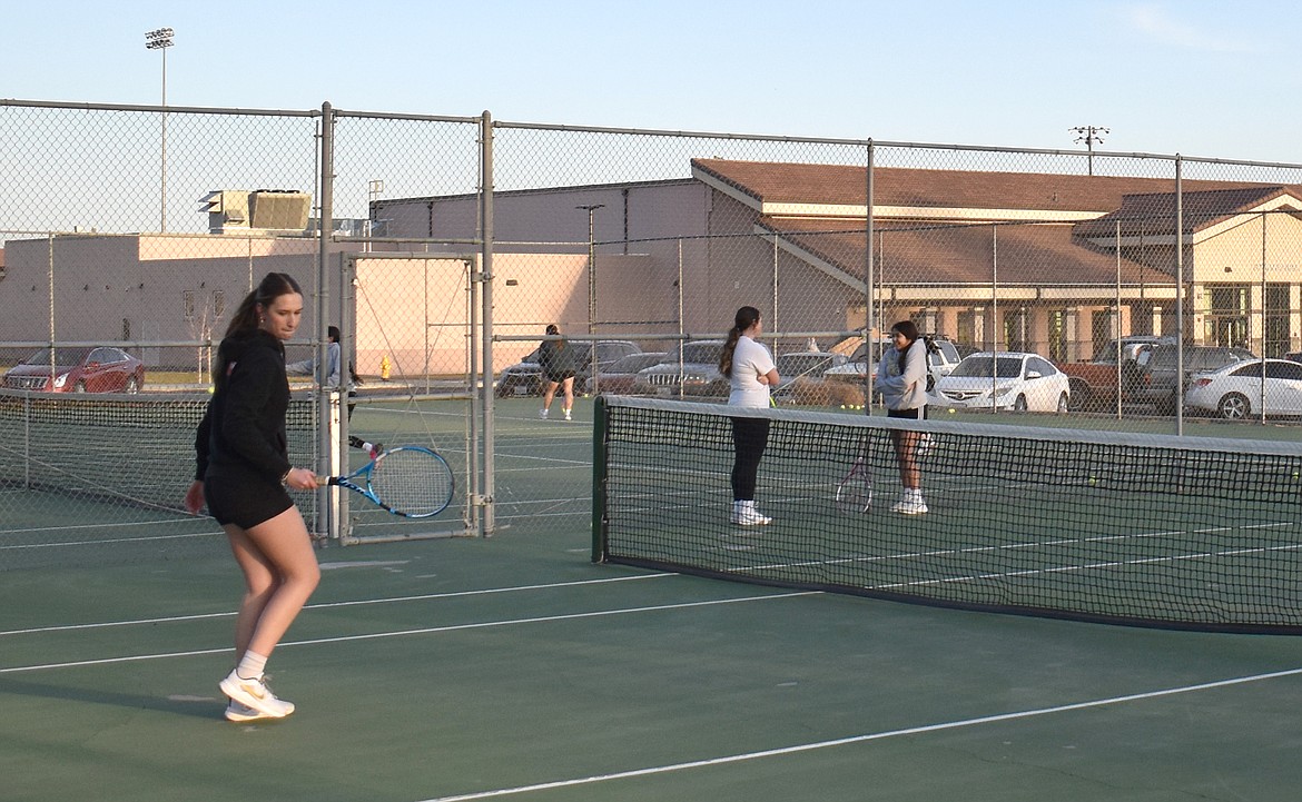 Royal sophomore Madyn Smith keeps her eye on the ball at Knights tennis practice Thursday.