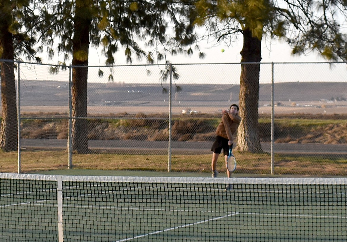 Kevin Ramirez serves the ball at Royal Knights tennis practice Thursday afternoon. The boys team isn’t as experienced as the girls, but they’re coming along.