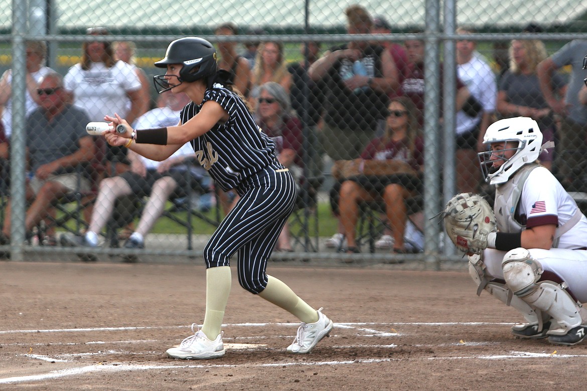 Royal senior Jaya Griffin, left, prepares to bunt in the 2023 1A state championship game against Montesano.