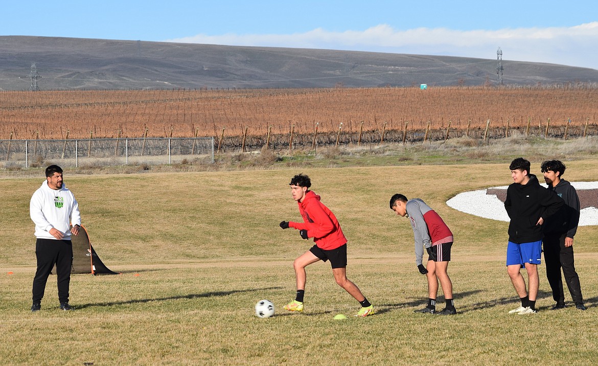 Wahluke Boys Soccer Head Coach Cele Lopez, left, directs players during practice drills at Wahluke High School.