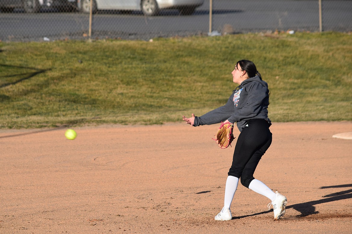 A pitcher for the Warden High School Varsity Softball team pitches the ball during a regular practice Tuesday evening.