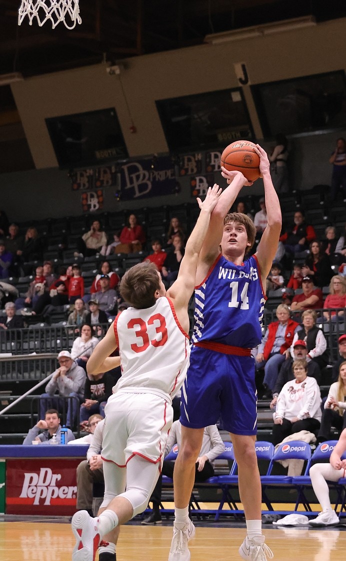 COLUMBIA FALLS guard Jace Hill goes up for the shot over Glendive’s Shann McPherson Friday morning at the State A boys basketball tournament. Hill had 27 points in the Wildcats’ 67-61 victory. (Gregory Nelson/artwestimage.com)