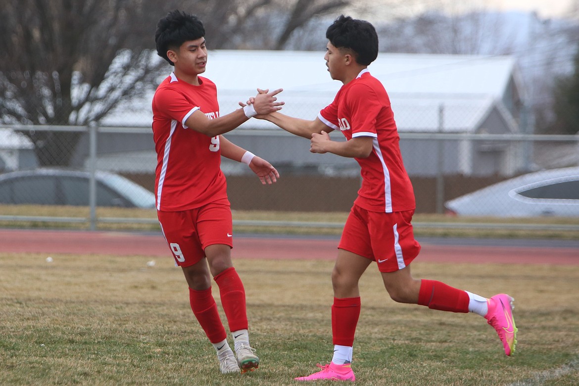 Othello junior Larry Maldonado (9) and junior Ruben Mancilla, right, celebrate after Maldonado scored a goal in the first half against Connell.