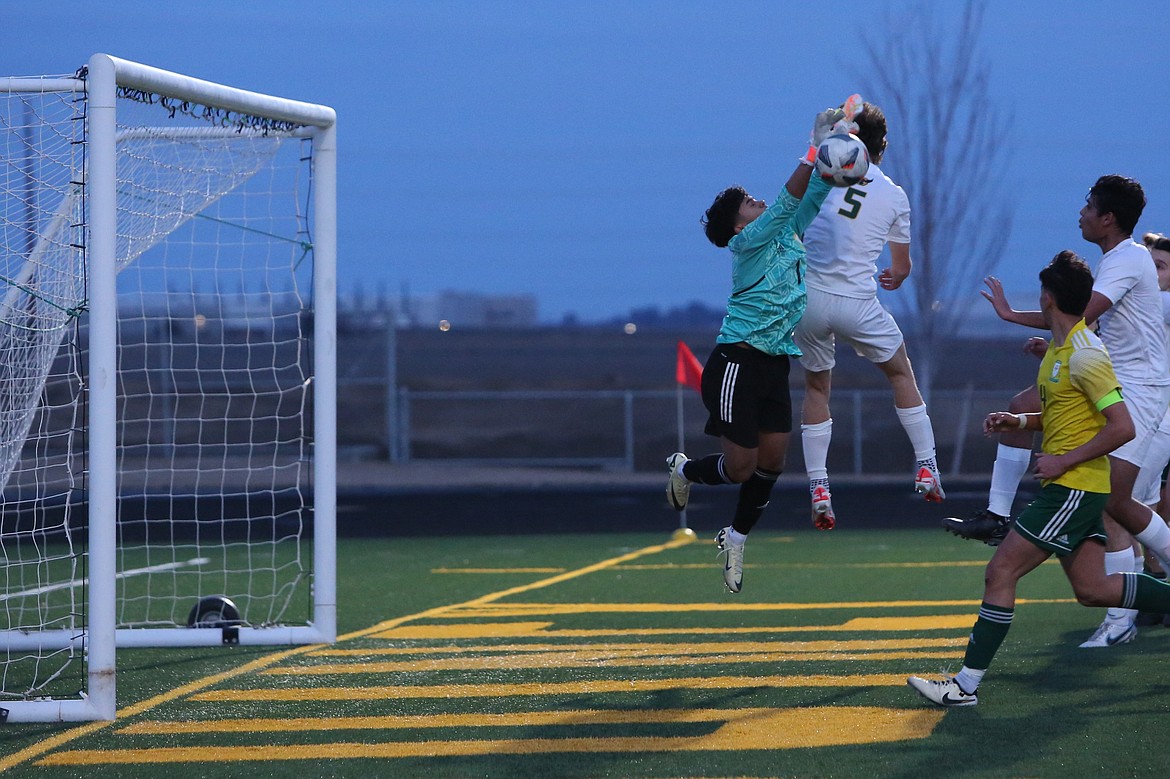 Quincy junior Momo Sandoval (1) blocks an Overlake shot in the first half.