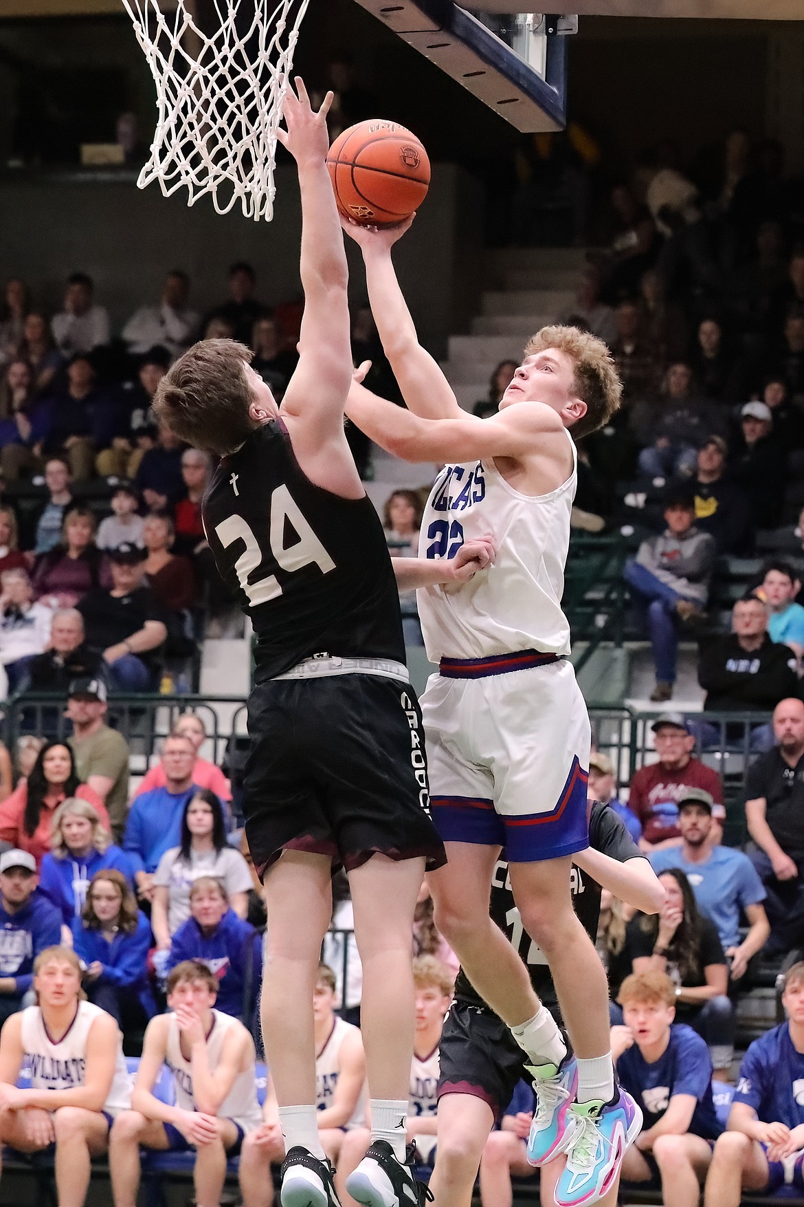 COLUMBIA FALLS' Reggie Sapa (22) goes up for two against Butte Central's Jack Keeley (24) during Saturday's State A boys consolation game. Sapa and the Wildcats won 58-53. (Gregory Nelson/artwestimage.com)