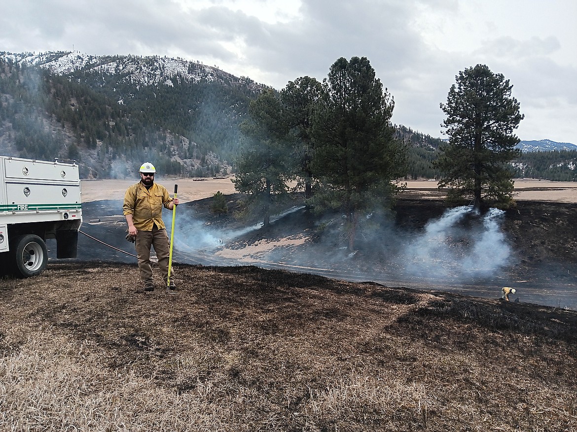 A field fire in the Tarkio area got loose Saturday and burned a little over 30 acres. Jake Fallis with the 9-Mile USFS supervised a small crew on Sunday as it was still a threat with the wind. Nathan Tomascak, with the same unit is below working the hot spots. (Monte Turner/Mineral Independent)