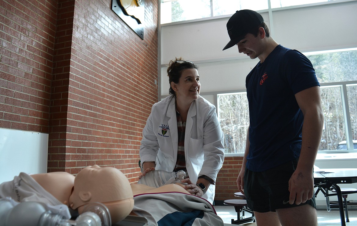 Elizabeth Babcock instructs Mykah Gray in patient resuscitation with a training bag in the cafeteria at Kellogg High School. Babcock is currently working towards her physician's assistant degree through Yale University and working at Shoshone Medical Center.
