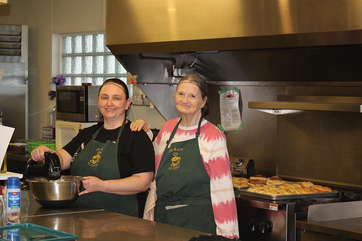 Mistydawn Holyoak, left, and Patricia McKague are making humongous cinnamon rolls in the kitchen of the St. Regis Senior Citizens Center on Friday and Saturday mornings.