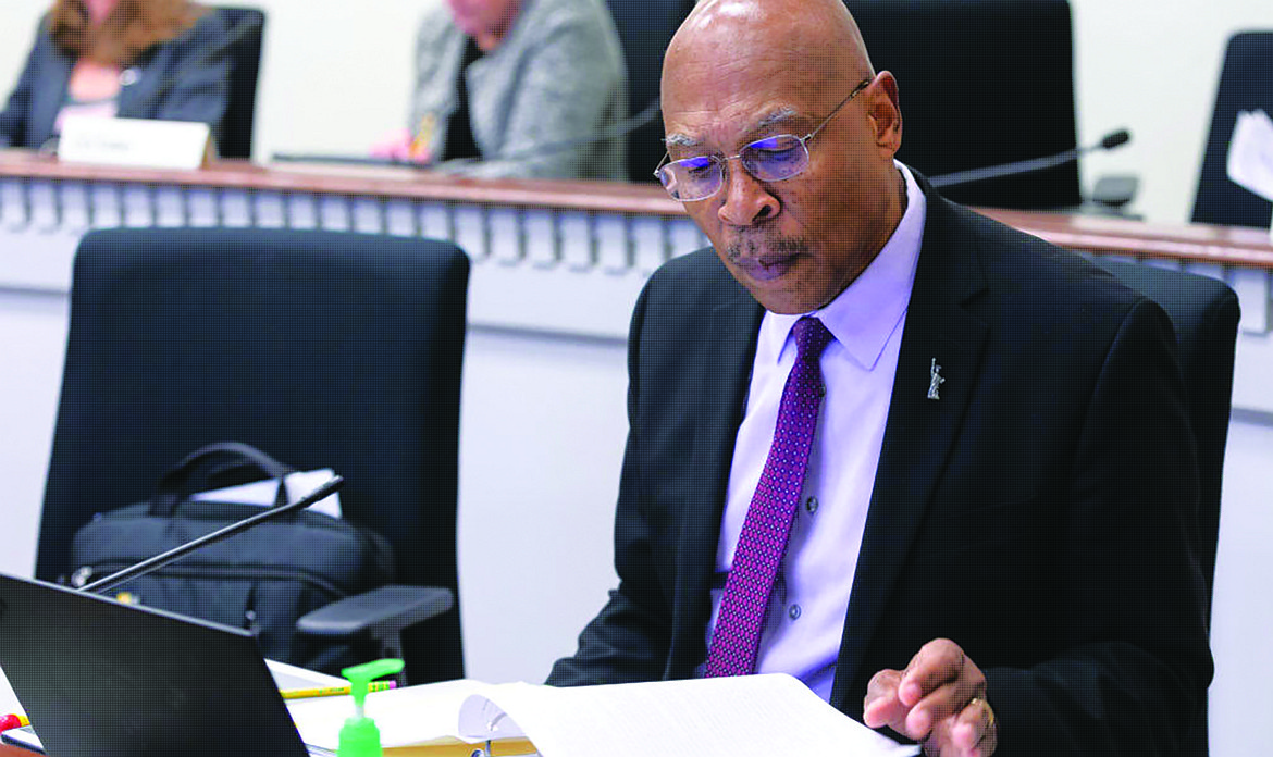 Sen. John Lovick studies a proposal at his desk on the floor of the Senate.