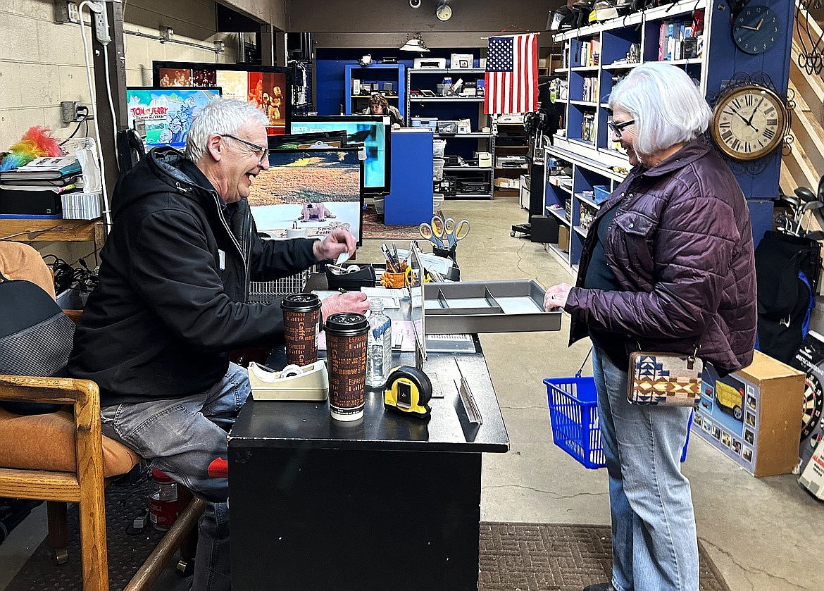 Del Simchuk laughs as he prices an item for Tawny Mitchell at St. Vincent de Paul.