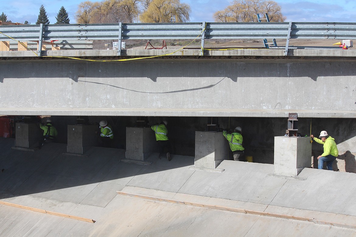 Each pillar has to be checked as crews lower Bridge 202 onto its temporary supports.