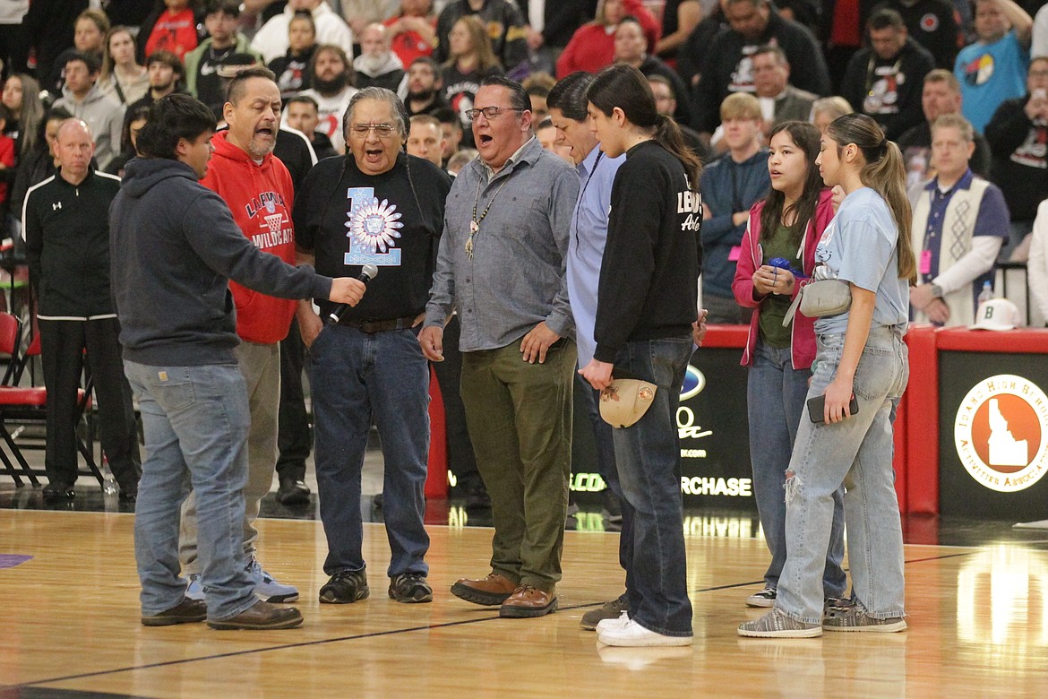 MARK NELKE/Press
Members of the Coeur d'Alene Tribe and Nezperce Tribe come together to sing the flag song of the Nezperce Tribe prior to the state 1A Division 1 boys basketball championship game between Lakeside and Lapwai on March 2 at the Ford Idaho Center in Nampa.