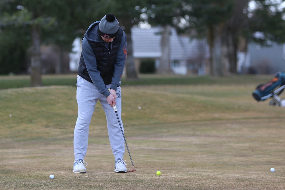 Lind-Ritzville/Sprague senior Lance Williamson putts the ball on the green during a March 12 practice at the Ritzville Golf Course.