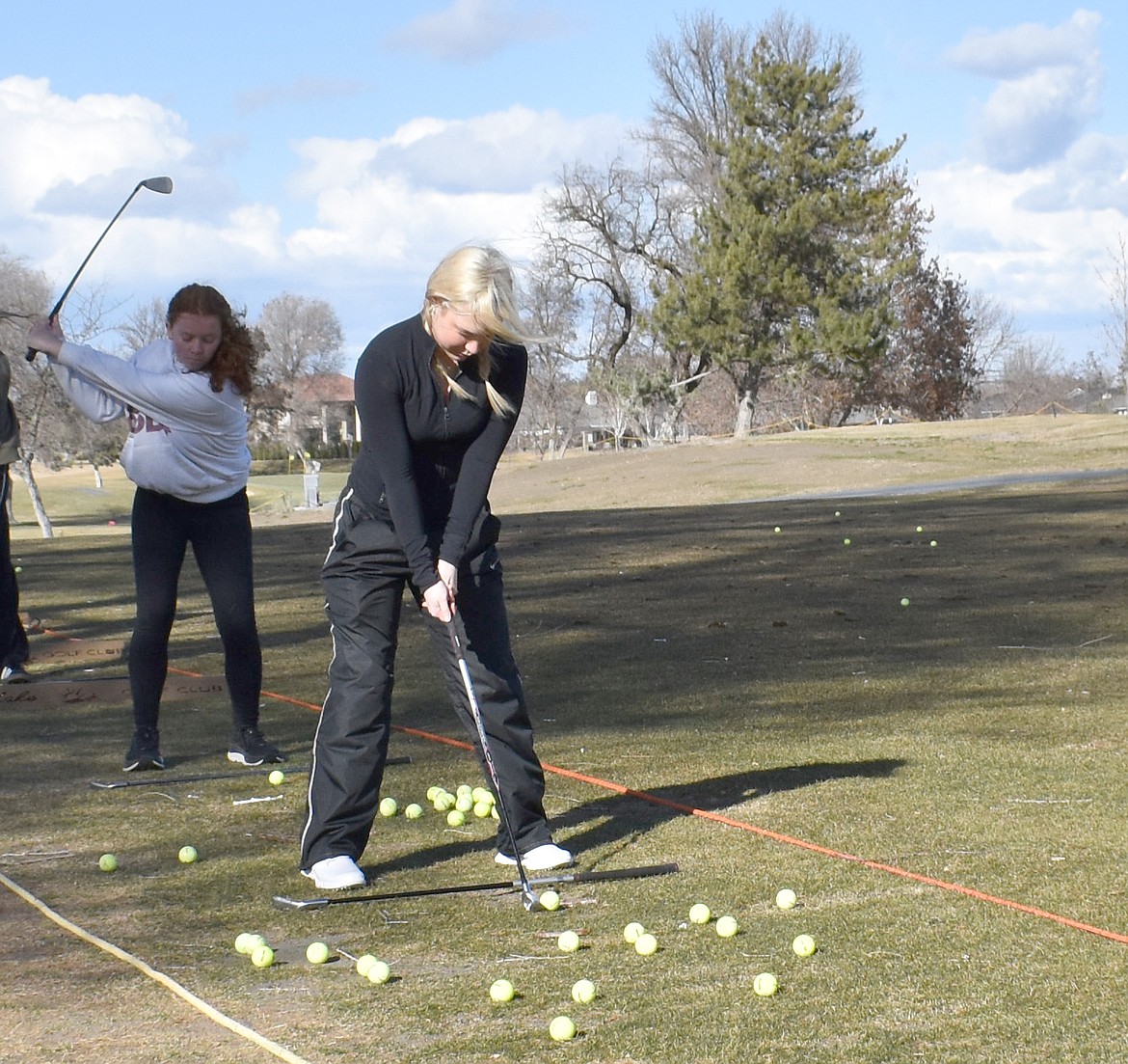 Ella Palmer, right, and Hayley Hardebeck work on their drive game at Moses Lake Golf & Country Club Tuesday.